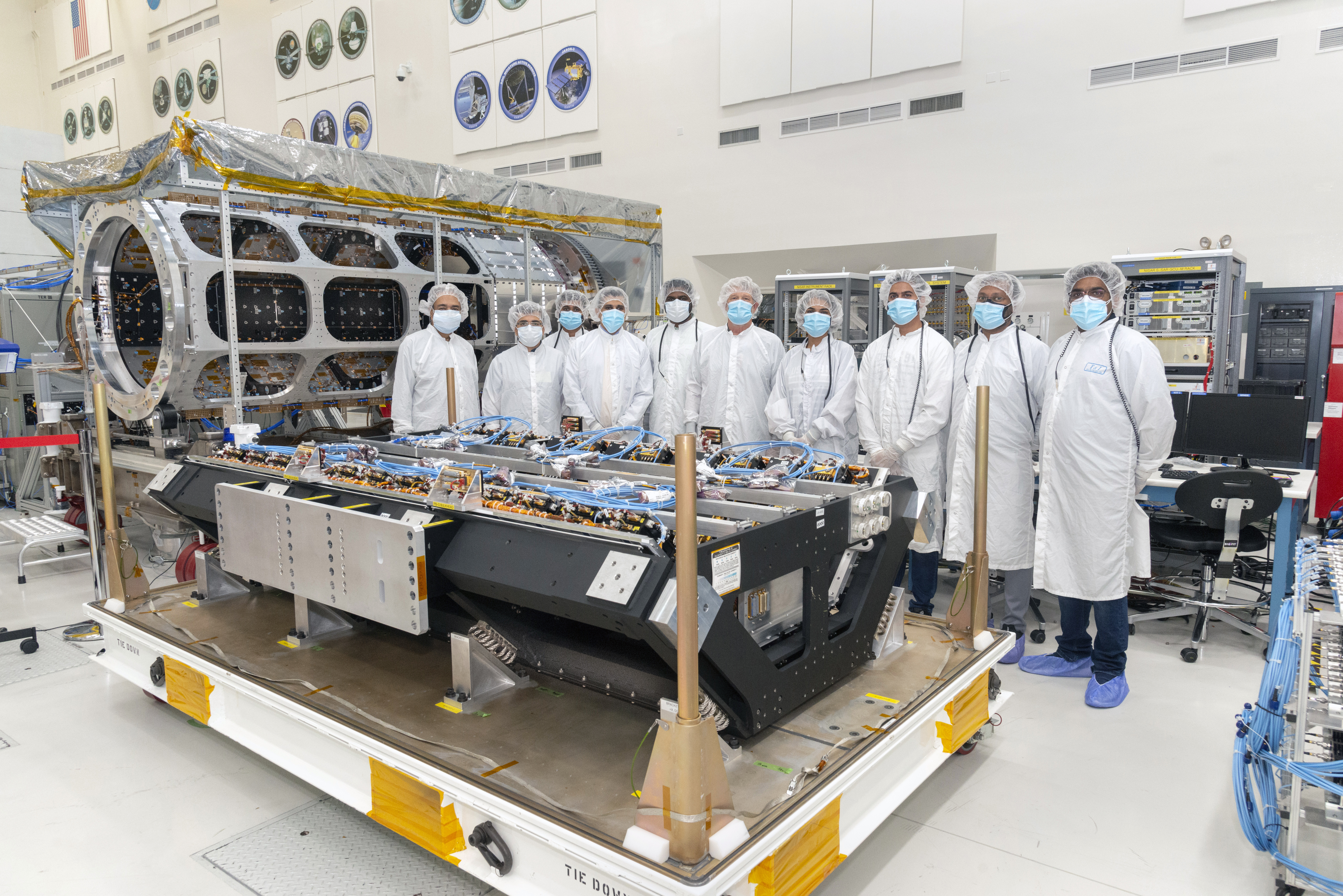 Members of the integration and test team, from NASA's Jet Propulsion Laboratory and the Indian Space Research Organization, with NISAR's S-synthetic aperture radar instrument at JPL.